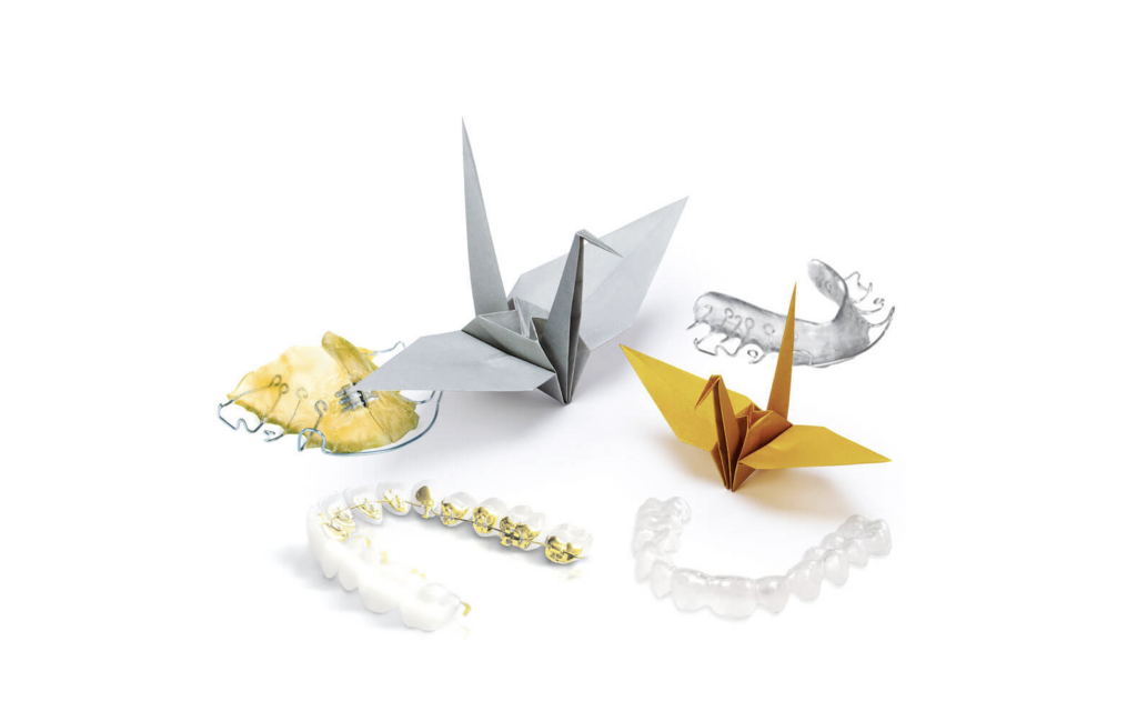 Origami-Kraniche zwischen Alignern und Zahnspangen